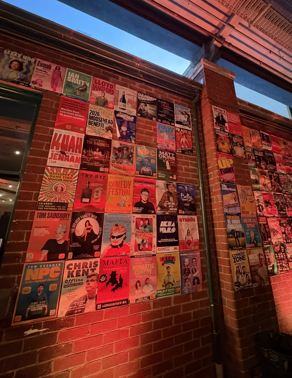 A wall of comedy show posters