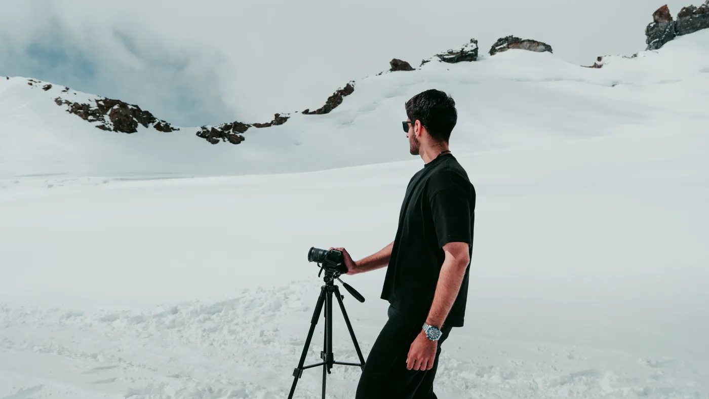 Filming on a snowy mountain ridge